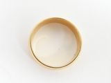 an image of a close up of a gold ring on a white surface