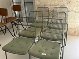 plusieurs chaises et une table dans une pièce, avec un mur en arrière-plan