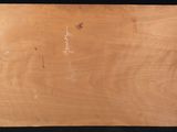 a close up of a piece of wood with writing on it