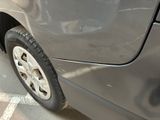 a close up of a car ' s tire on the side of the road