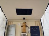 a box with a watch, a book, and other items in it