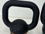 two kettle weights sitting next to each other on a table