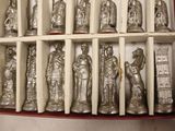 a collection of silver figurines in a display case