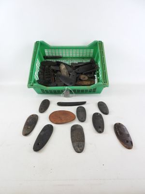 several pieces of wood are in a green basket next to a penny