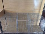 a cage that is sitting on the floor in the room