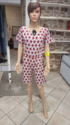 a mannequin wearing a red and white dress on display