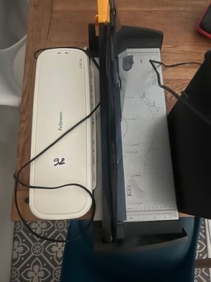 a laptop computer sitting on top of a desk next to a cell phone
