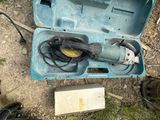 a tool in a blue case on the ground