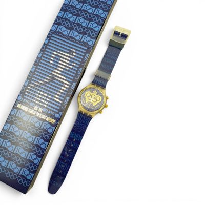 an image of a watch sitting on top of a box next to a tie