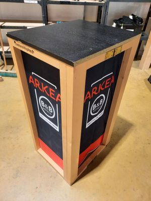 une boîte en carton sur laquelle est collée une étiquette noire et rouge