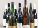 several bottles of wine are lined up in a row on a table