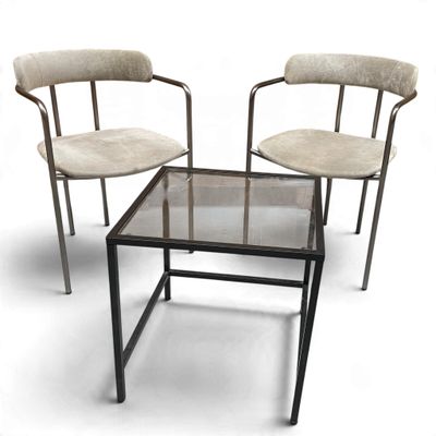 two chairs and a table with a glass top on a white background