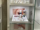 a glass display case in the corner of a bathroom