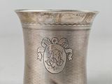 an antique silver cup with a lion emblem on the side