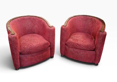 pair of art deco lounge chairs in red velvet upholstered with brass trim
