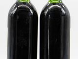 two bottles of wine sitting next to each other on a table