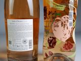 two bottles of wine sitting next to each other on a table