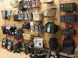 many bags hanging on the wall in the store