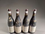 four bottles of wine are lined up on a table