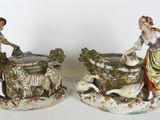 pair of figurines of a man and a woman with a dog