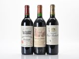 three bottles of wine are lined up on a white surface
