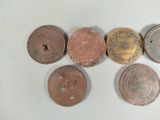 several different types of coins are arranged on a white surface