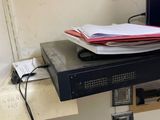 an image of a desk with a computer monitor and files on it