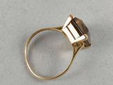 a close up of a gold ring with a stone in it