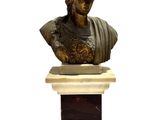 statue of a bust of a man with a hat on top of a pedestal