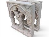 a stone bench that has a couple of columns on top of it