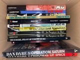 many books stacked on top of each other in a box