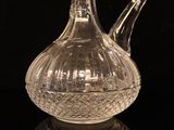 a glass pitcher that is sitting on a black surface