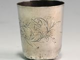 a silver cup that has a design on it