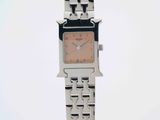 an image of a woman ' s wrist watch with a square face
