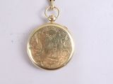 a gold locke with a picture of a man and a woman on it
