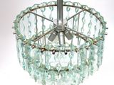 a glass chandelier hanging from the ceiling