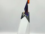 a glass sculpture of a sailboat on a white surface