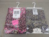 two pairs of women ' s floral pants are on display in a store
