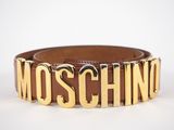 a brown leather belt with the word moschino on it