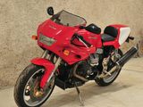 a red motorcycle that is parked in a garage