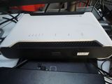 a white and black computer sitting on top of a desk