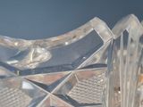 a clear glass vase with a bird on top of it