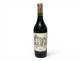 bottle of red wine on a white background with a building in the background