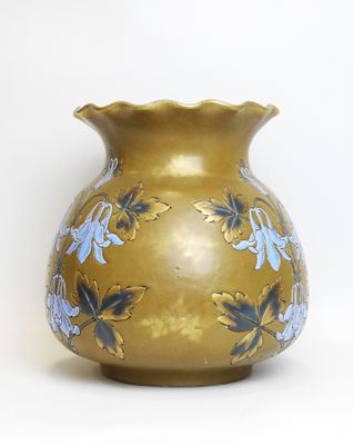 a gold vase with blue flowers on it on a white background