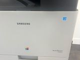 a white printer with a black and white printer on top of it