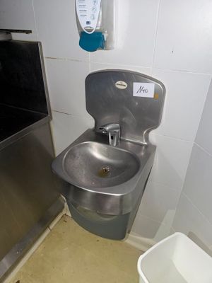 a sink and a trash can in a small room