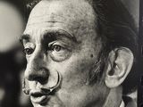 a black and white photo of a man with a nose ring