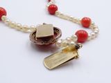a necklace with a heart and a tag on it