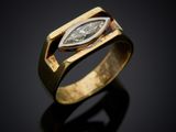 a gold ring with a pear shaped diamond in the center