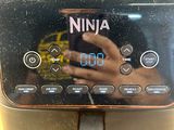 a close up of a coffee machine with a person taking a picture of it
